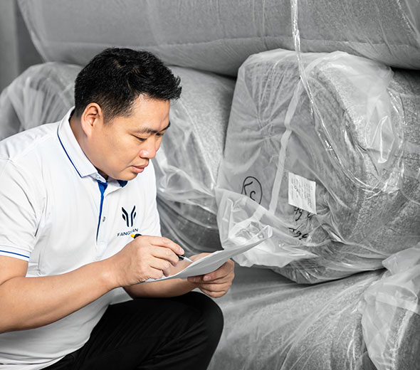 A QC is checking the raw material fabric